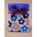 Super MINI fold flat gift box with velcro fastener and flower print with ribbon detail.